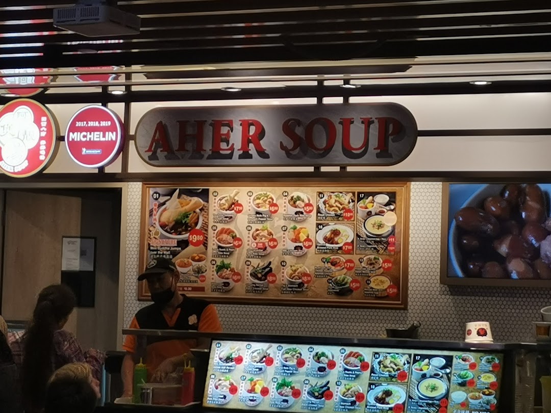 Aher Soup stall in Kopitiam Food Hall, featuring a large menu board and a staff member serving customers.