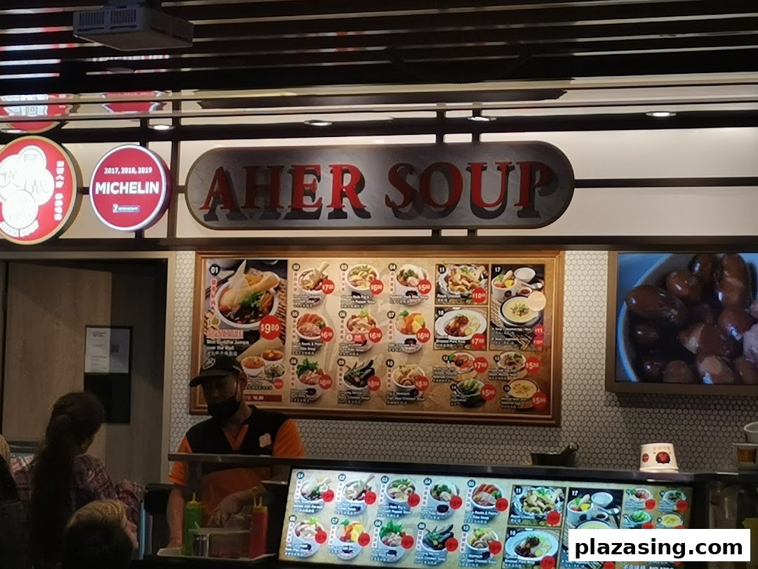 Aher Soup stall in Kopitiam Food Hall, featuring a large menu board and a staff member serving customers.