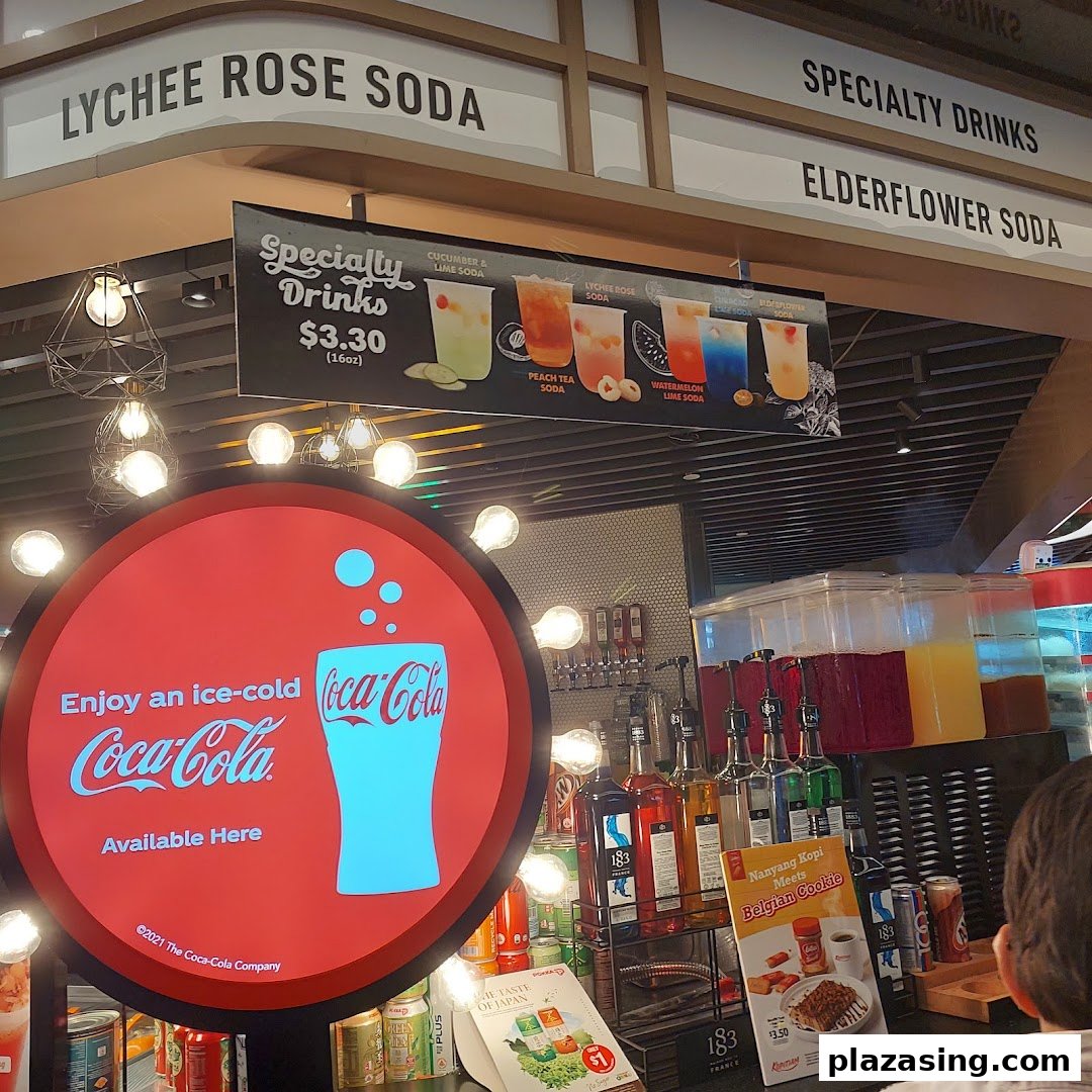 A drinks counter at Kopitiam Food Hall showcasing specialty sodas and Coca-Cola offerings.
