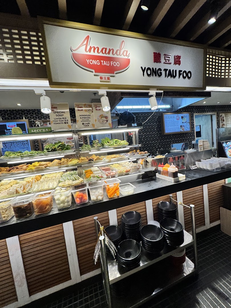 A vibrant food stall counter showcasing a wide selection of fresh Yong Tau Foo ingredients.
