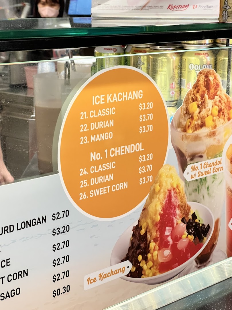 A menu board displaying prices and varieties of Ice Kachang and Chendol, with images of the desserts.