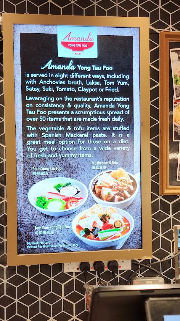 A digital menu board showcasing Amanda Yong Tau Foo's offerings with various broth options and fresh ingredients.