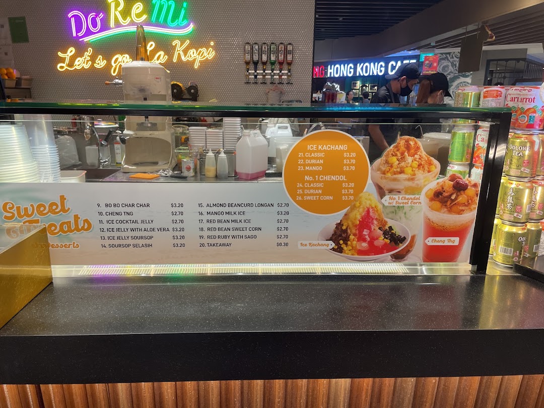 A vibrant dessert counter featuring a menu board with various sweet treats and shaved ice desserts.