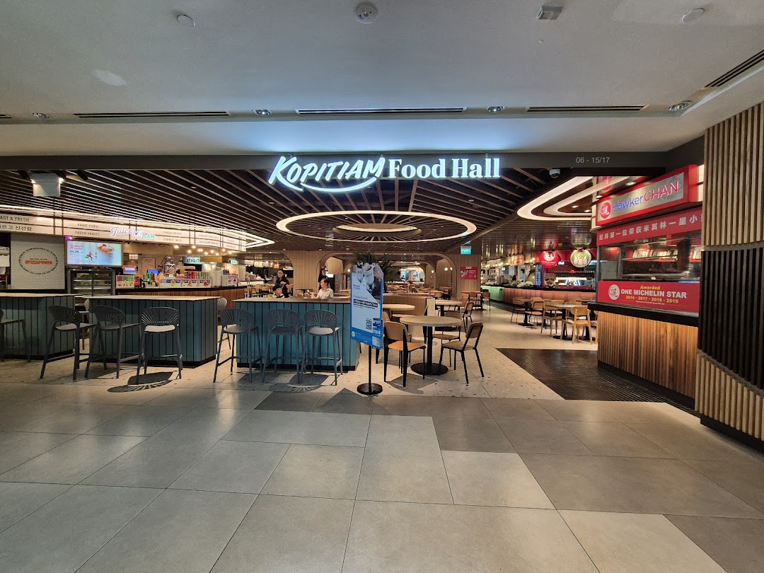 A wide view of Kopitiam Food Hall entrance, showcasing diverse food stalls and seating areas.