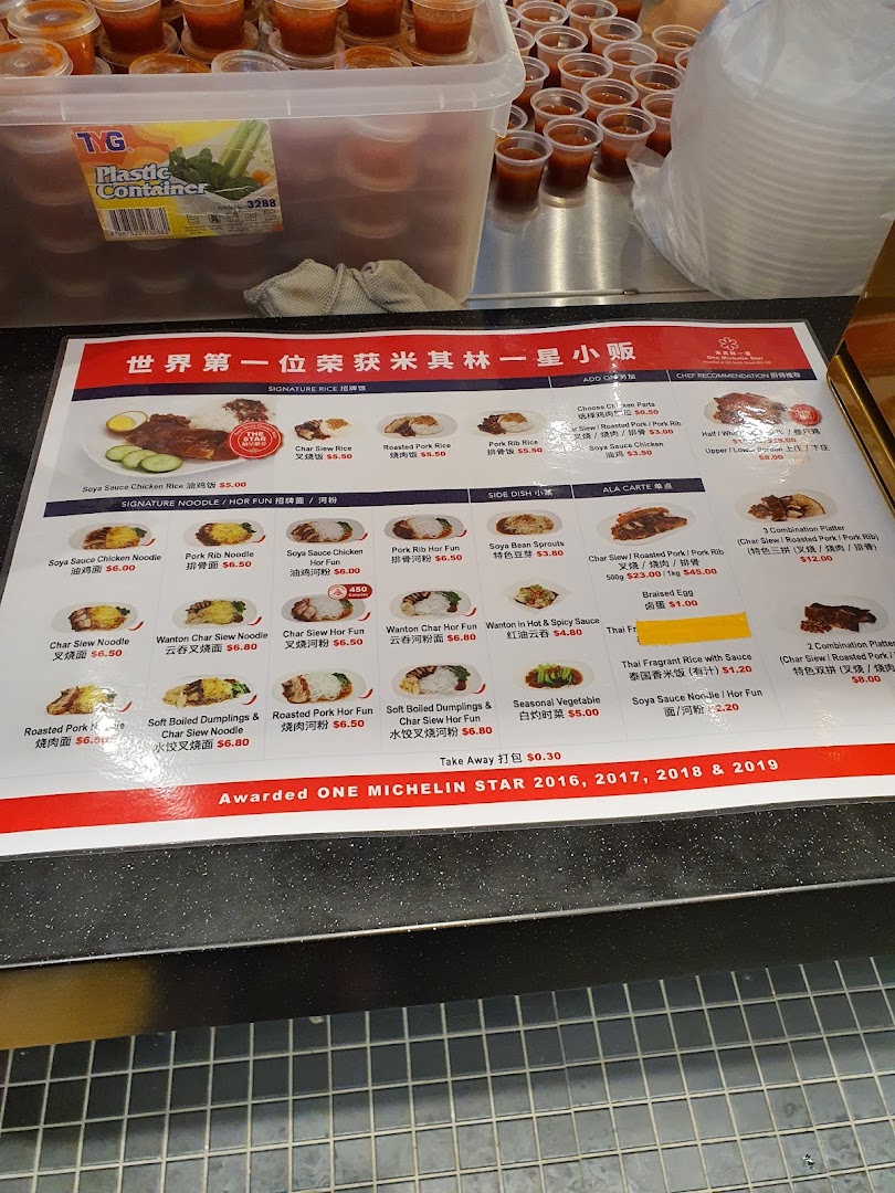 A detailed menu board displaying various rice, noodle, and side dishes with prices at Kopitiam Food Hall.
