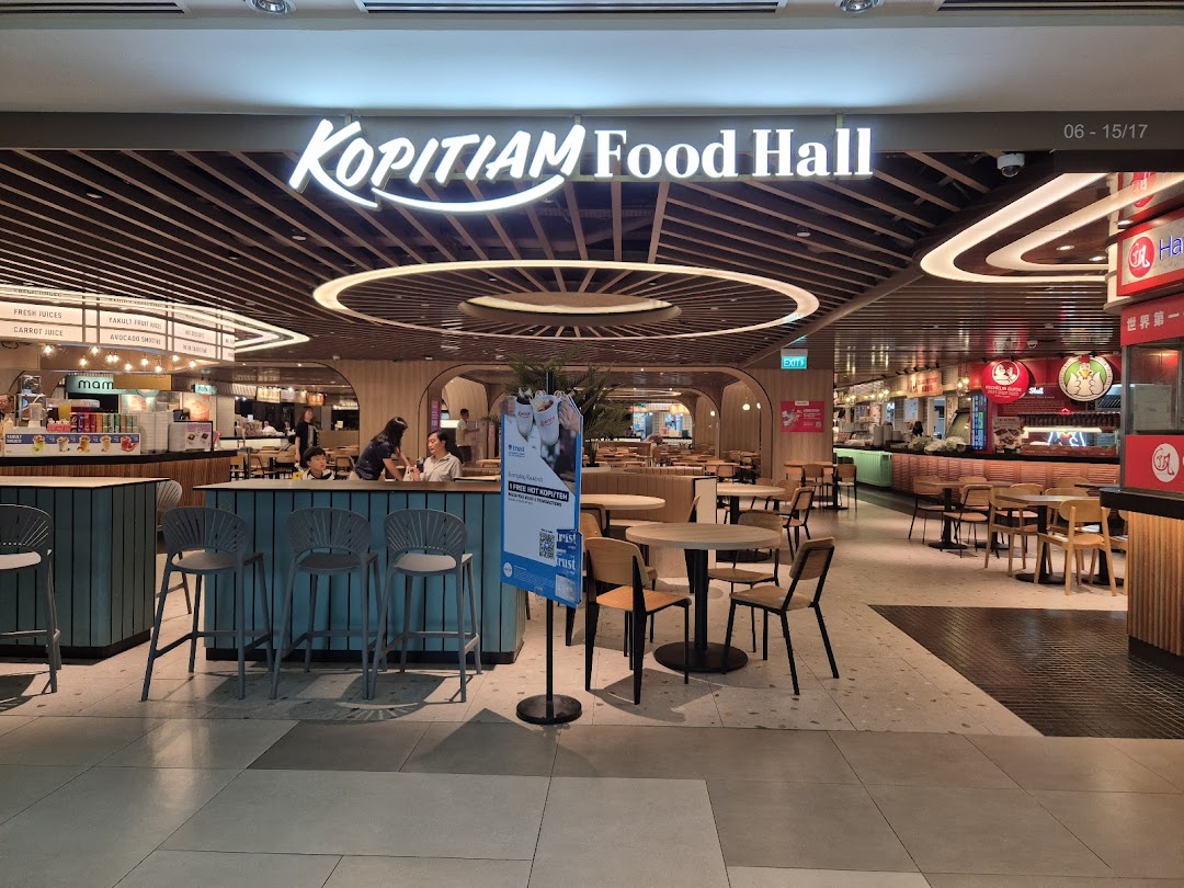 A wide view of Kopitiam Food Hall entrance, showcasing its spacious interior and various food stalls.