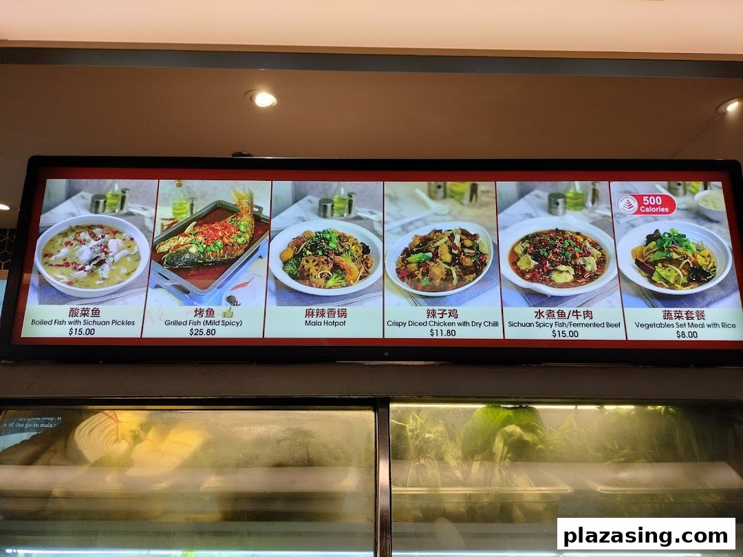 A digital menu board at Kopitiam Food Hall displaying various Sichuan and Chinese dishes with prices.