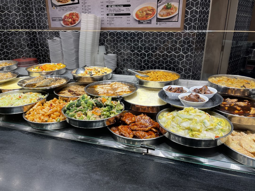 A vibrant display of diverse Asian dishes with a visible menu board at Kopitiam Food Hall.