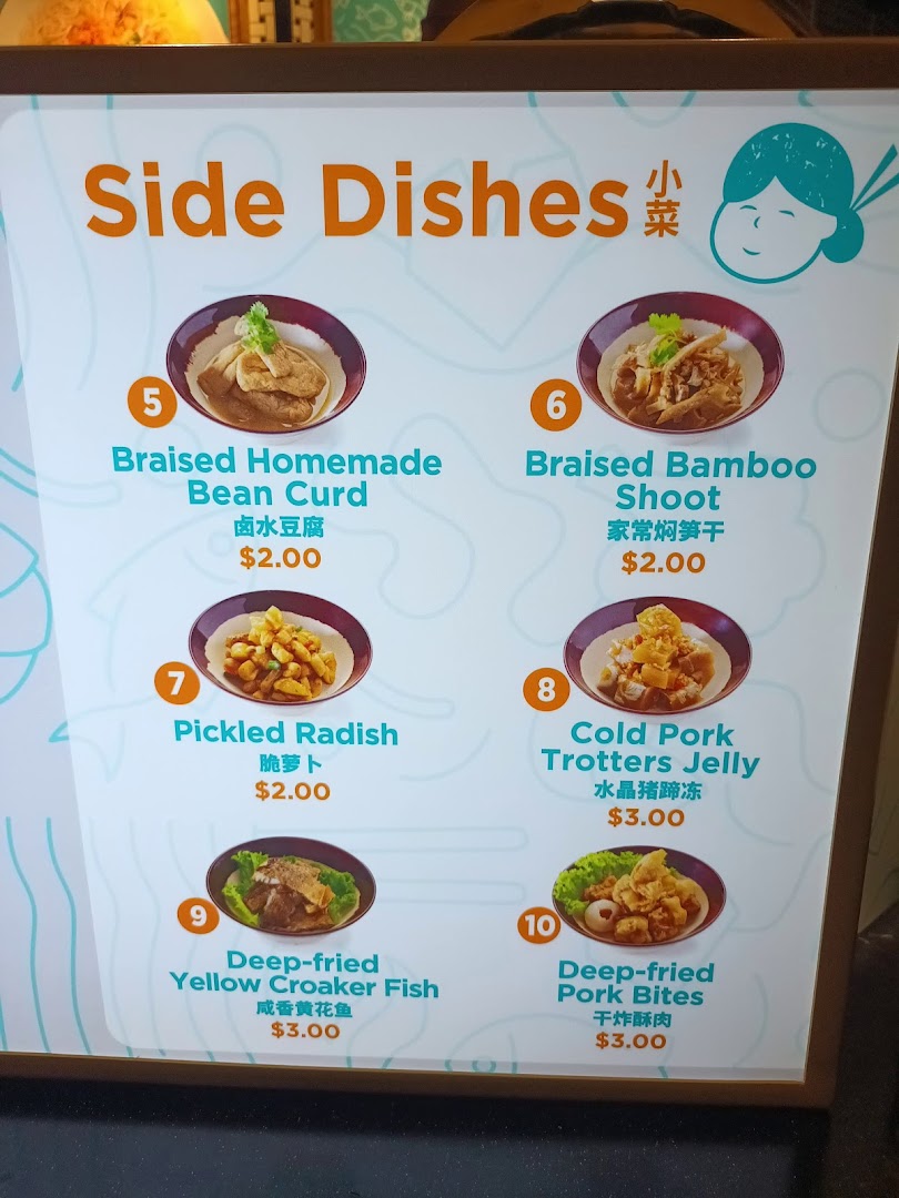 A digital menu board displaying various side dishes and their prices at Kopitiam Food Hall.