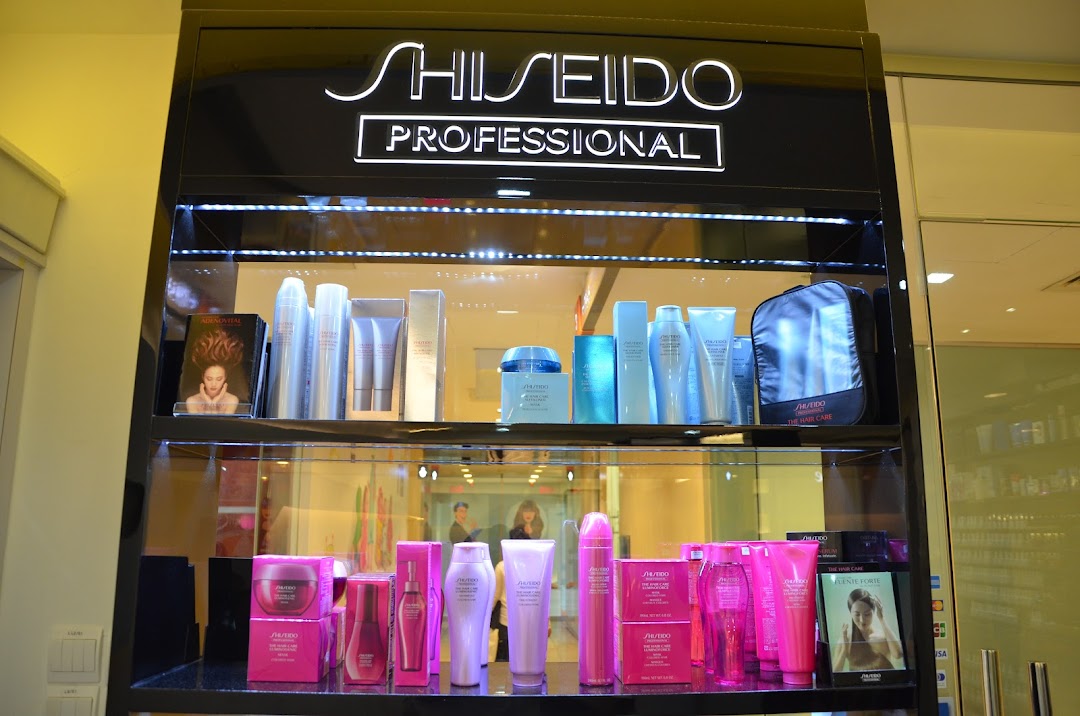 A brightly lit display cabinet showcasing Shiseido Professional hair and skincare products in a retail setting.