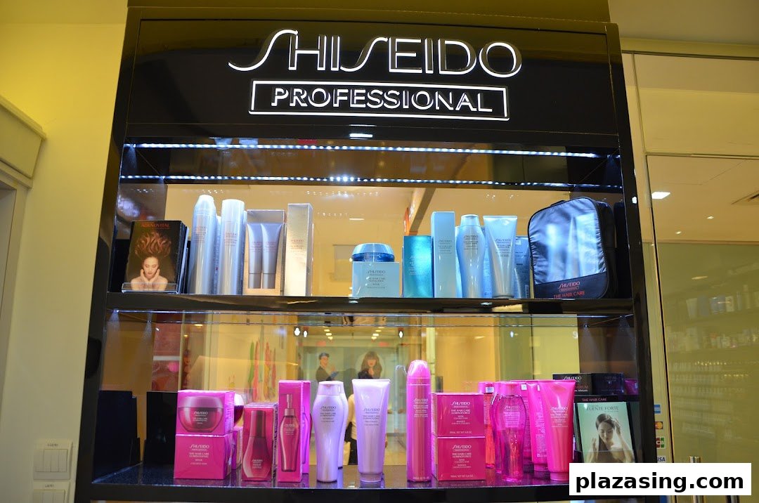 A brightly lit display cabinet showcasing Shiseido Professional hair and skincare products in a retail setting.