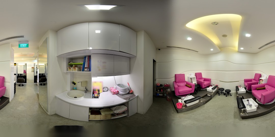 A modern salon interior featuring vibrant pink pedicure chairs and a hair styling section.