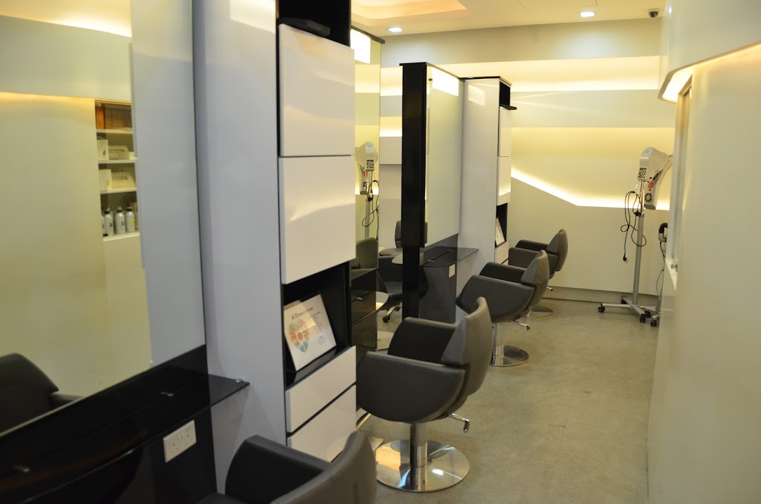 Interior view of a modern salon with multiple styling stations, chairs, and mirrors.