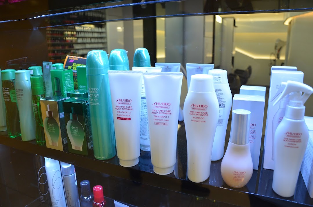 A display of Shiseido professional hair care products, including shampoos and treatments, on a retail shelf.