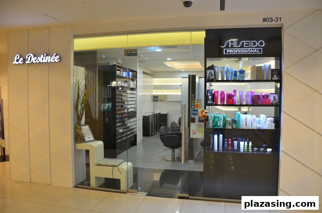 The shop front of Le Destinee, a beauty salon, featuring a glass entrance and product display.