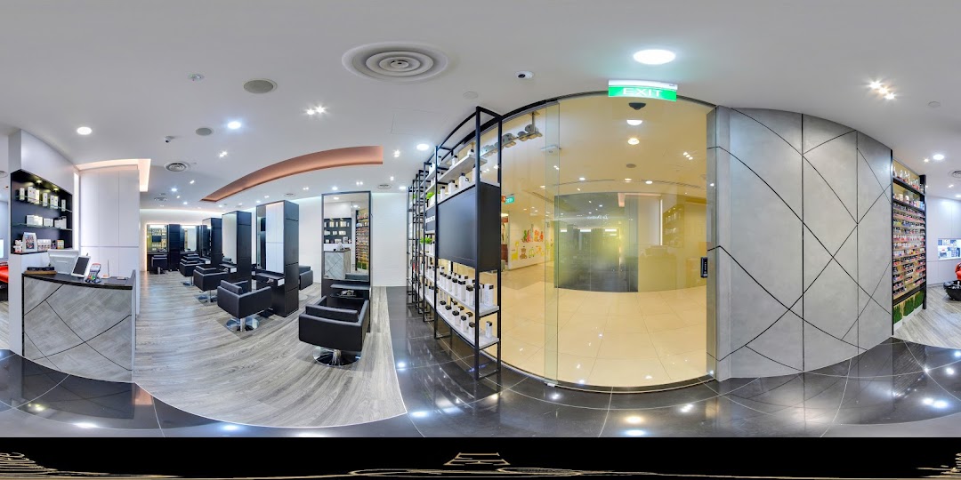 A modern hair salon interior with styling chairs, product displays, and a reception area.