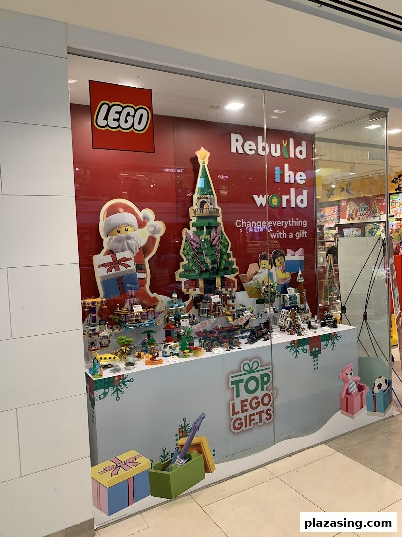A festive LEGO Certified Store window display featuring Christmas decorations and various LEGO sets.