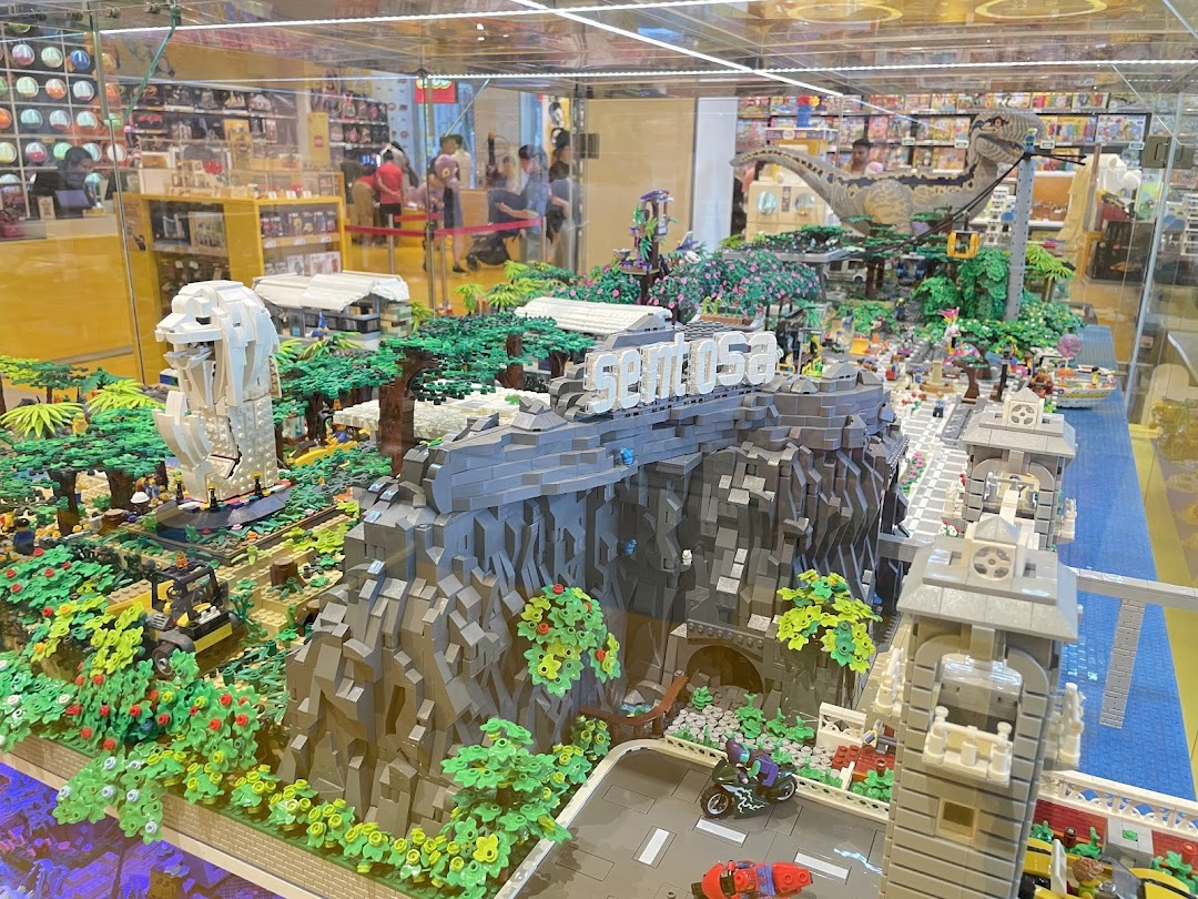 An intricate LEGO diorama of Sentosa Island featuring the Merlion, a dinosaur, and detailed landscapes.