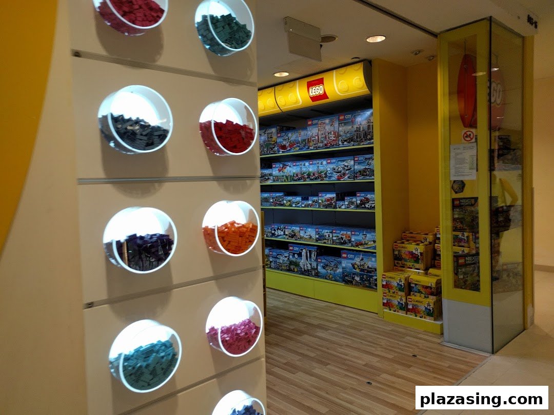 An interior view of a LEGO Certified Store, showcasing product displays and a colorful 'Pick a Brick' wall.