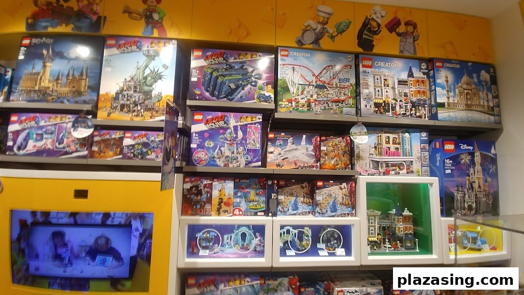 Shelves filled with diverse LEGO sets, including Harry Potter, Creator, and Movie themes, with an interactive display below.