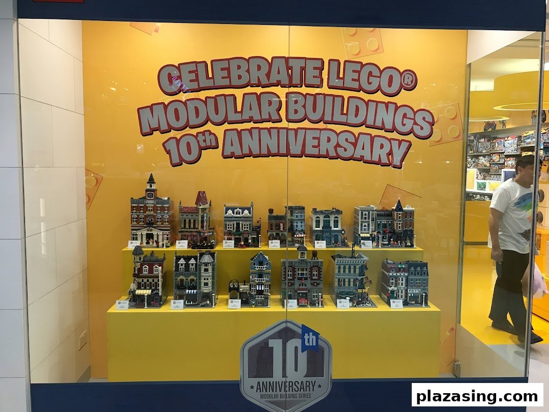 A vibrant LEGO store window display showcasing Modular Buildings for their 10th Anniversary.