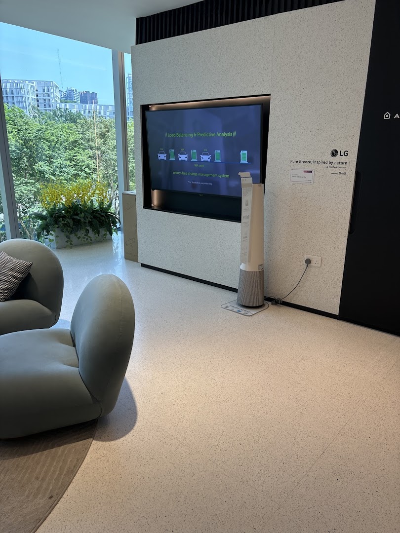 A modern retail interior featuring an LG display on energy solutions, comfortable seating, and a scenic view.