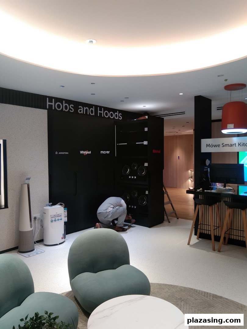Interior view of Life by City Energy showroom featuring kitchen appliances and a person working on an installation.