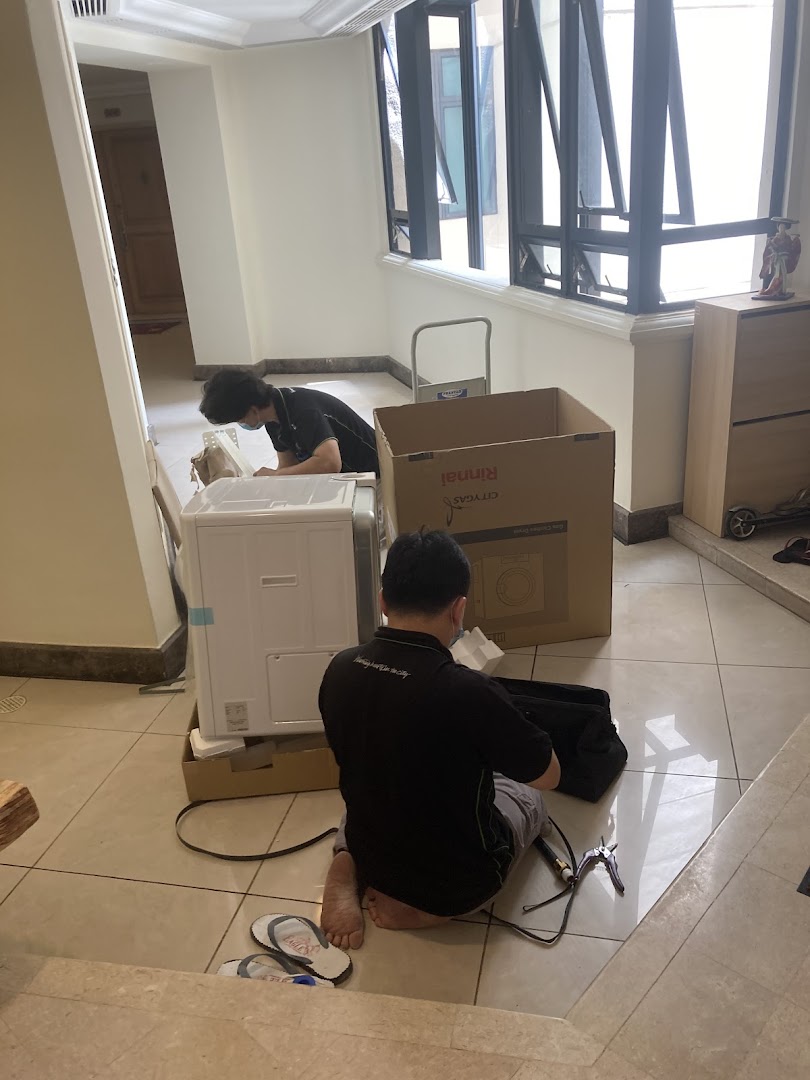 Technicians from Life by City Energy are professionally assembling a Rinnai appliance indoors.