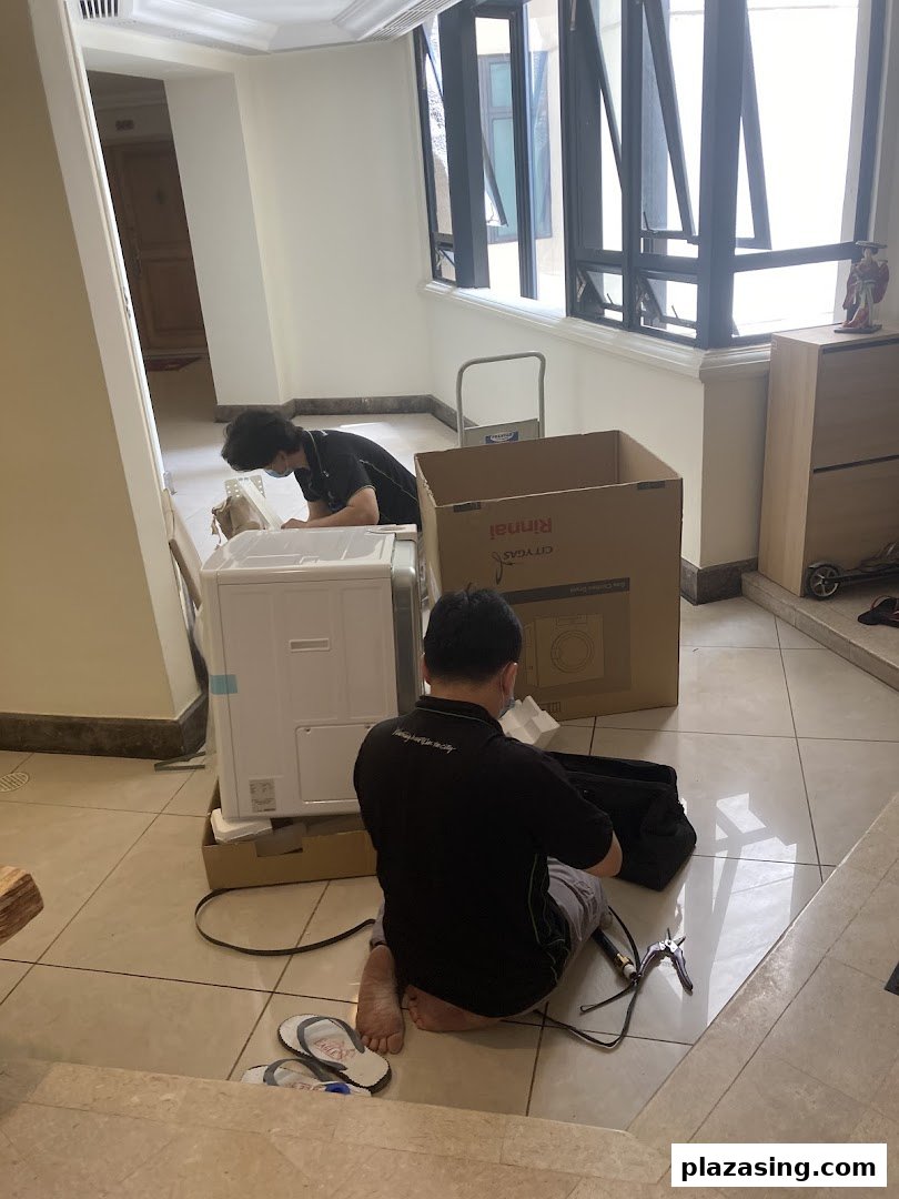Technicians from Life by City Energy are professionally assembling a Rinnai appliance indoors.