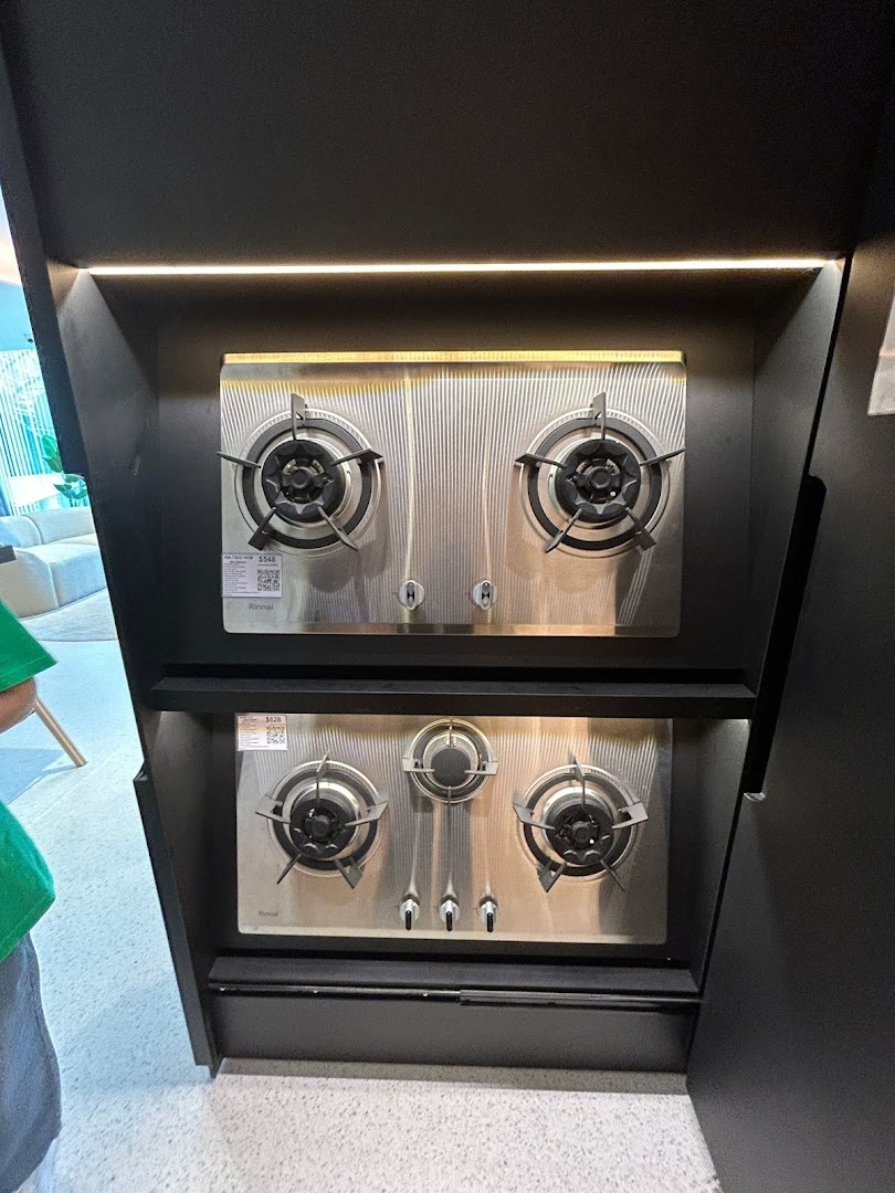 Two modern stainless steel gas hobs displayed in a retail setting.