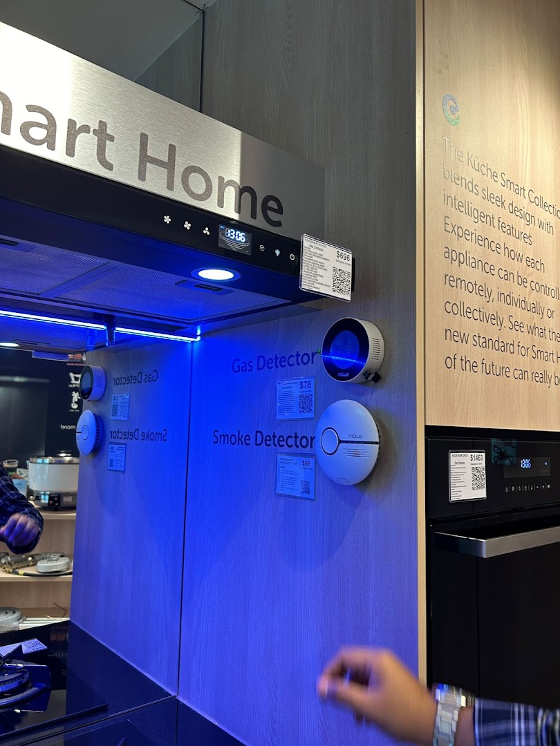 A display of smart home appliances including a range hood, gas detector, and smoke detector.