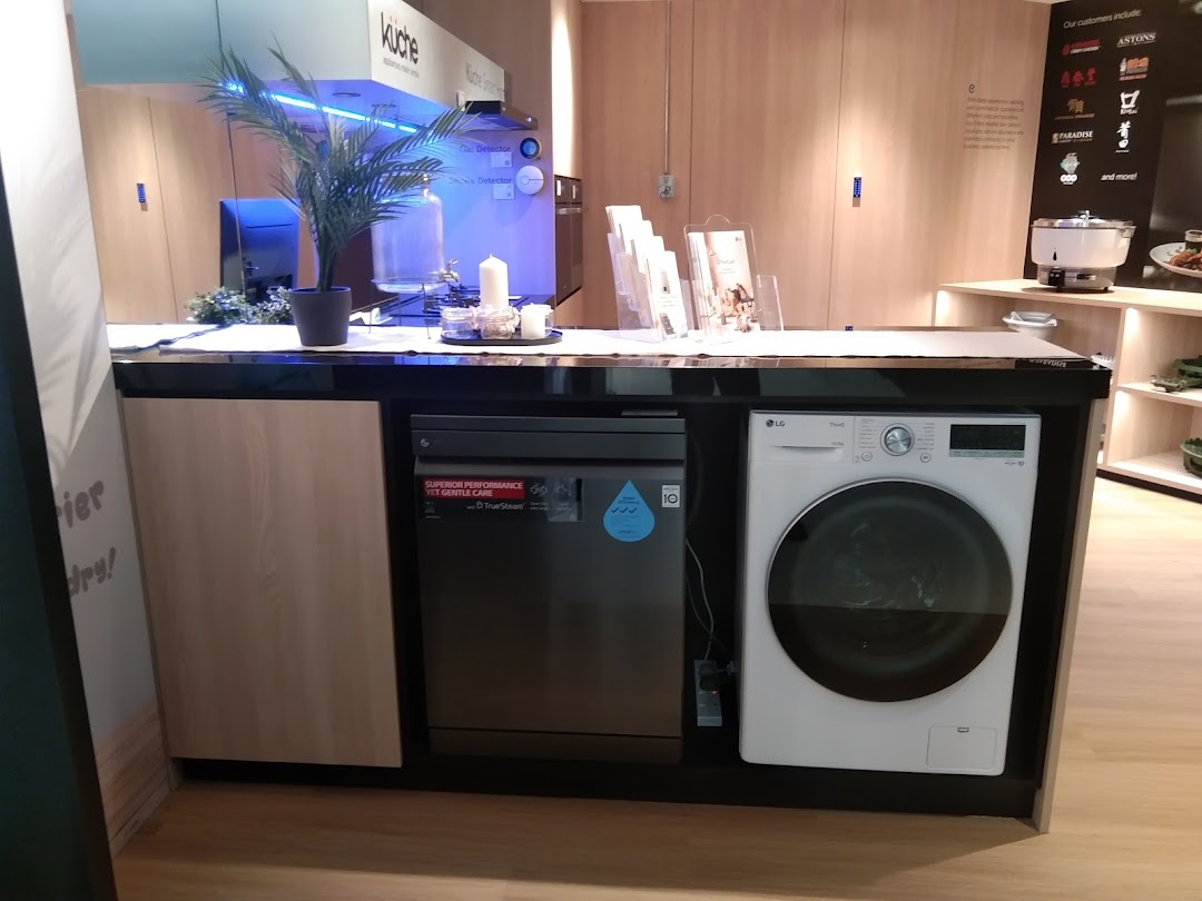 A modern display of LG home appliances, including a washing machine and dishwasher, in a showroom setting.