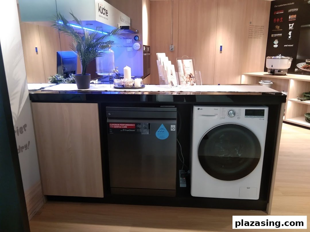 A modern display of LG home appliances, including a washing machine and dishwasher, in a showroom setting.
