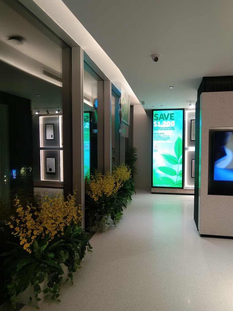 Modern interior of Life by City Energy with green displays, plants, and energy-saving promotions.