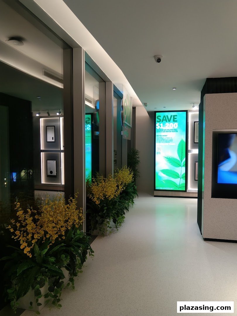 Modern interior of Life by City Energy with green displays, plants, and energy-saving promotions.