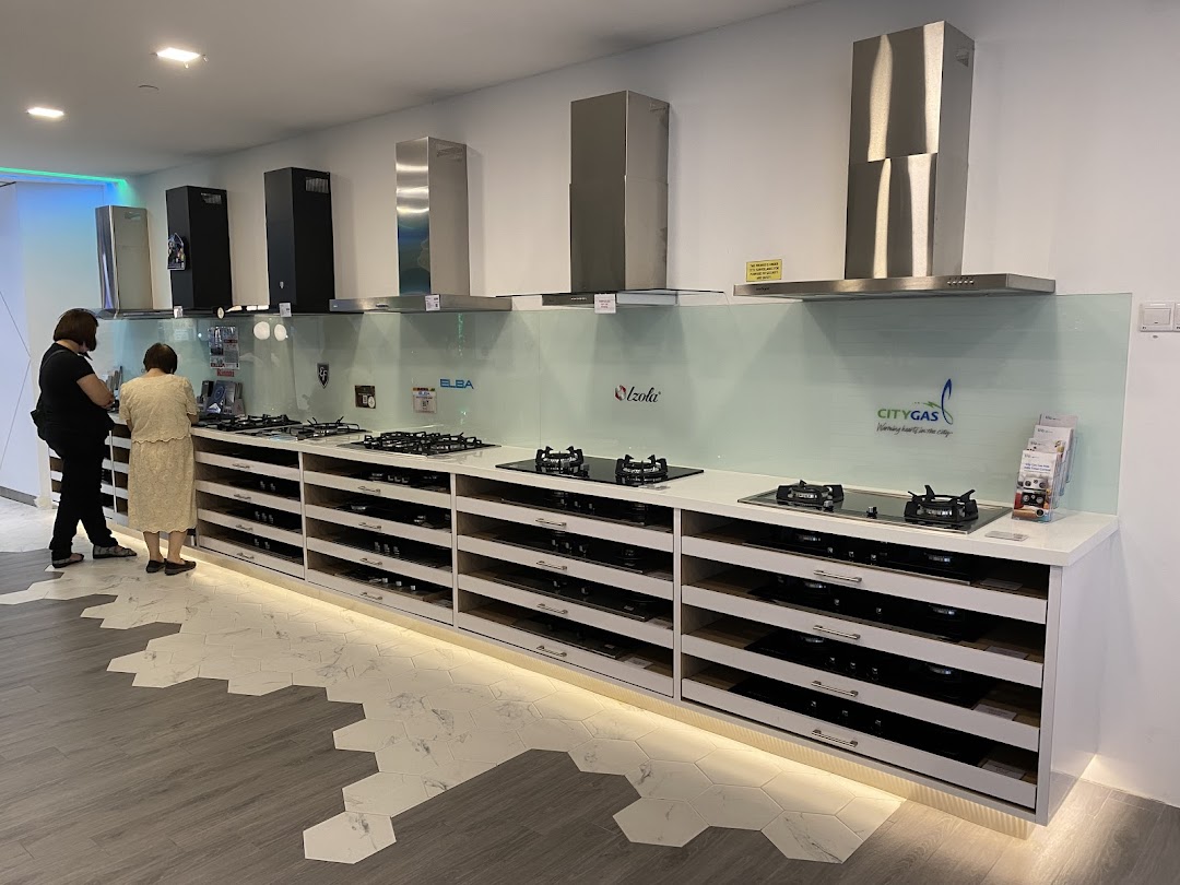Two customers browse a display of modern kitchen gas stoves and range hoods at Life by City Energy.