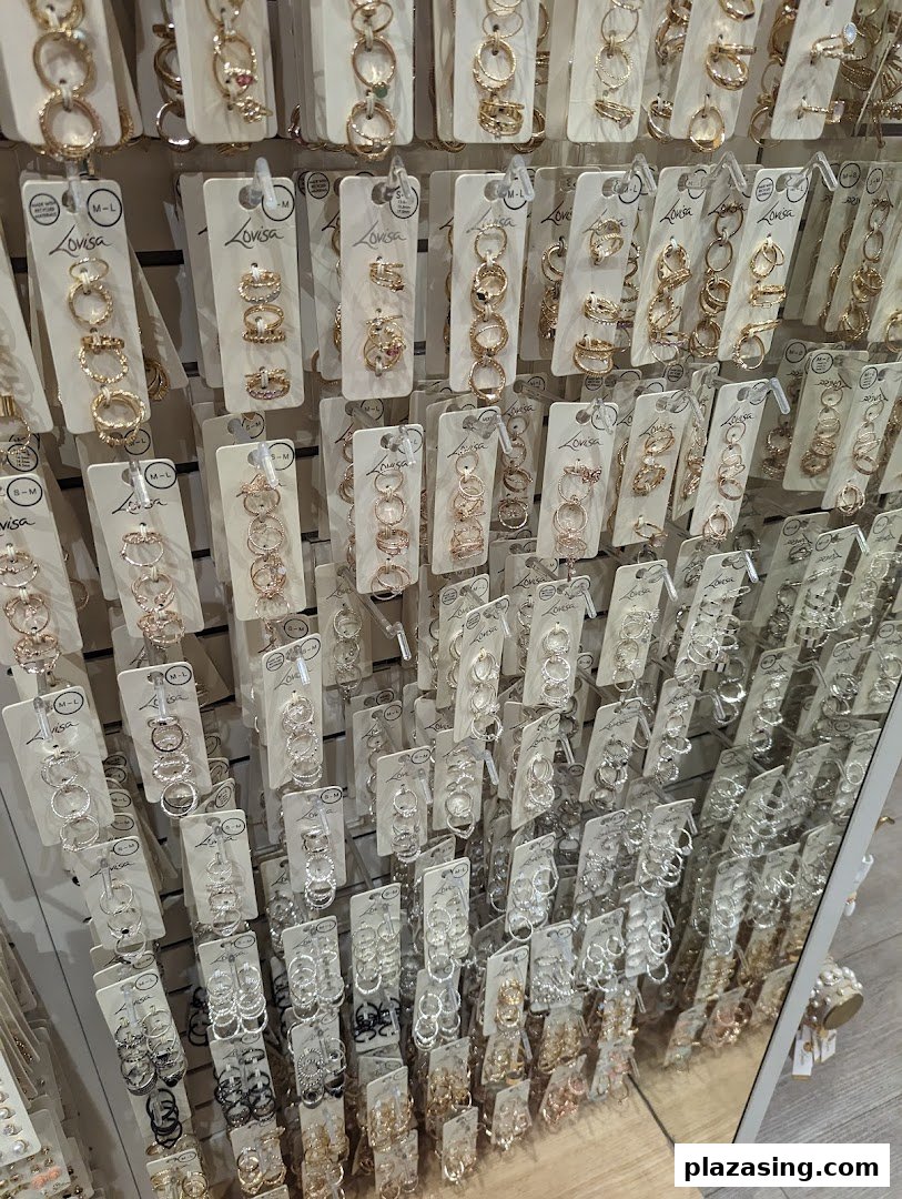 A wall display showcasing a wide variety of Lovisa rings in gold, silver, and rose gold tones.