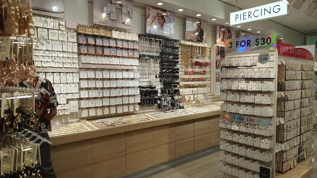 Interior view of a Lovisa store showcasing extensive displays of earrings, necklaces, and other fashion jewelry.