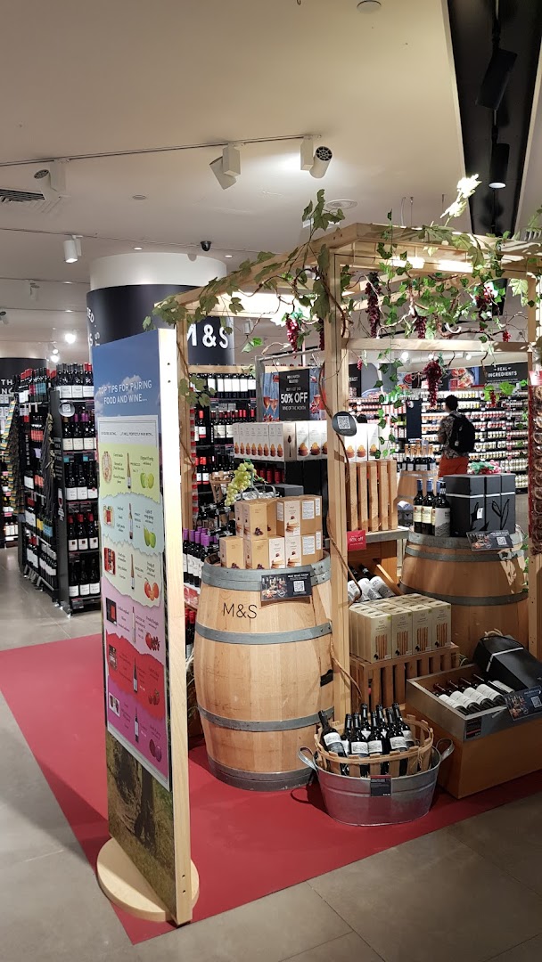 An in-store display at Marks & Spencer featuring wine, food pairings, and related products.