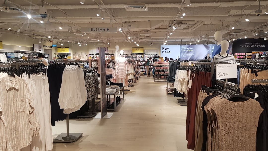 Interior view of Marks & Spencer, showcasing clothing racks, mannequins, and various apparel sections like lingerie.