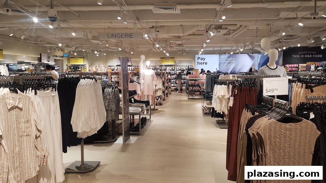 Interior view of Marks & Spencer, showcasing clothing racks, mannequins, and various apparel sections like lingerie.