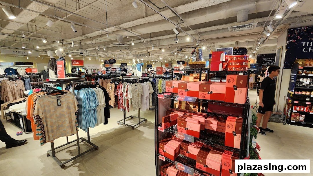 Interior view of Marks & Spencer, showcasing clothing racks, sale items, and festive food/gift displays.