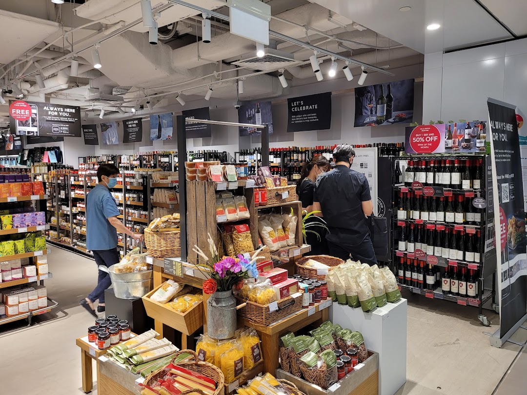 An interior view of Marks & Spencer's food hall, showcasing a wide selection of wines, groceries, and gourmet products.