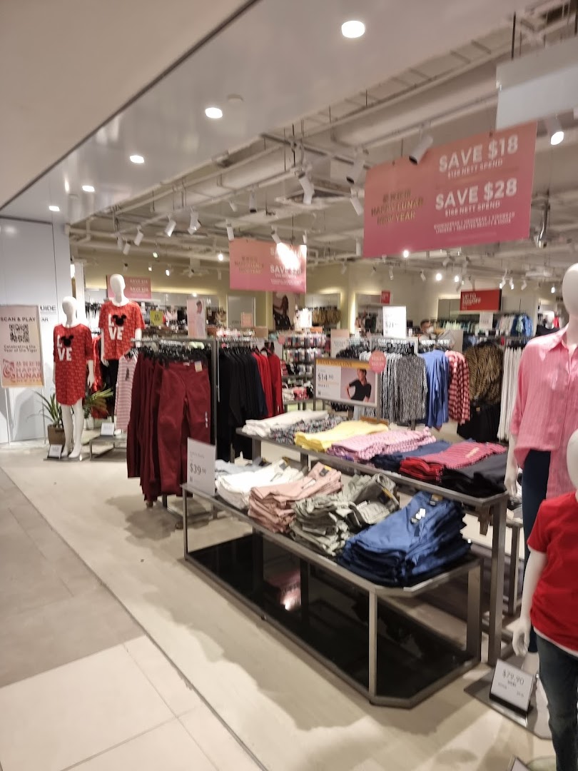 An interior view of Marks & Spencer showcasing clothing displays, mannequins, and promotional sale signs.