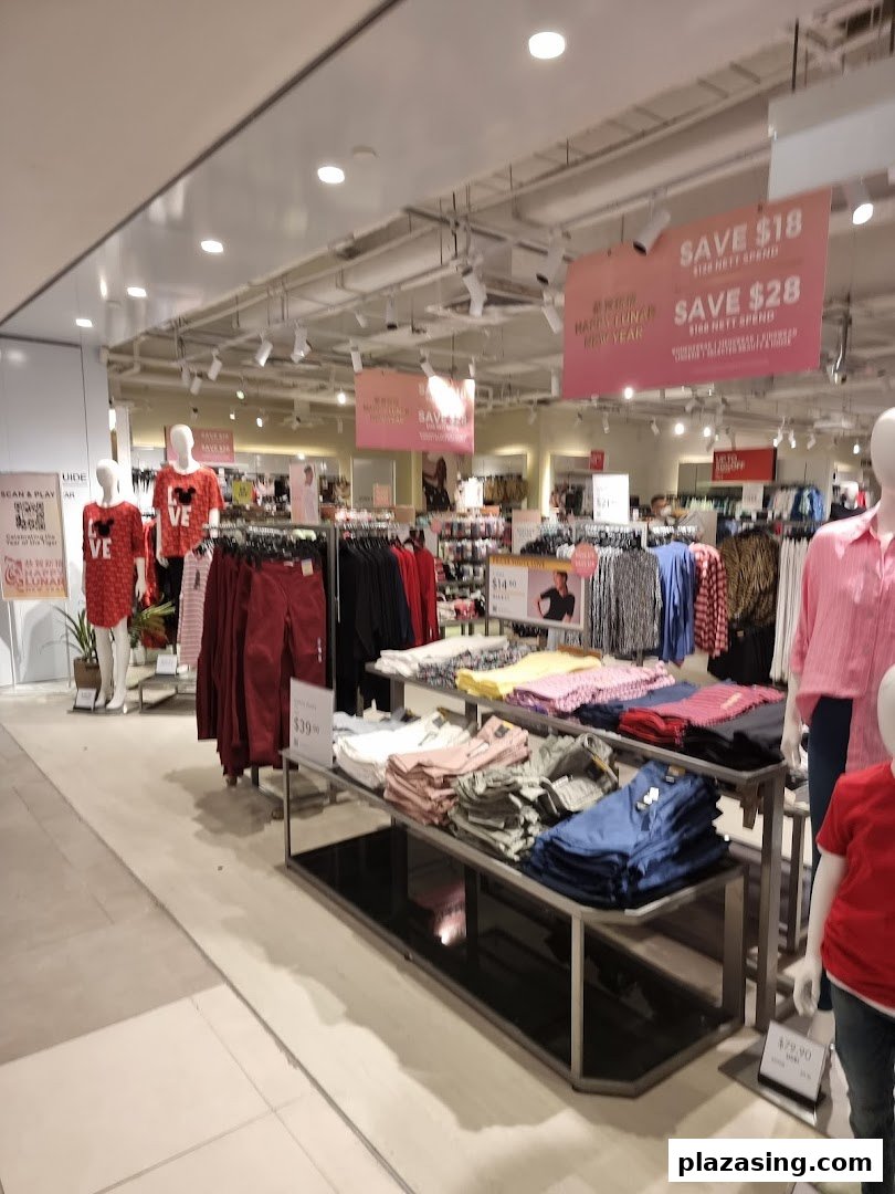 An interior view of Marks & Spencer showcasing clothing displays, mannequins, and promotional sale signs.