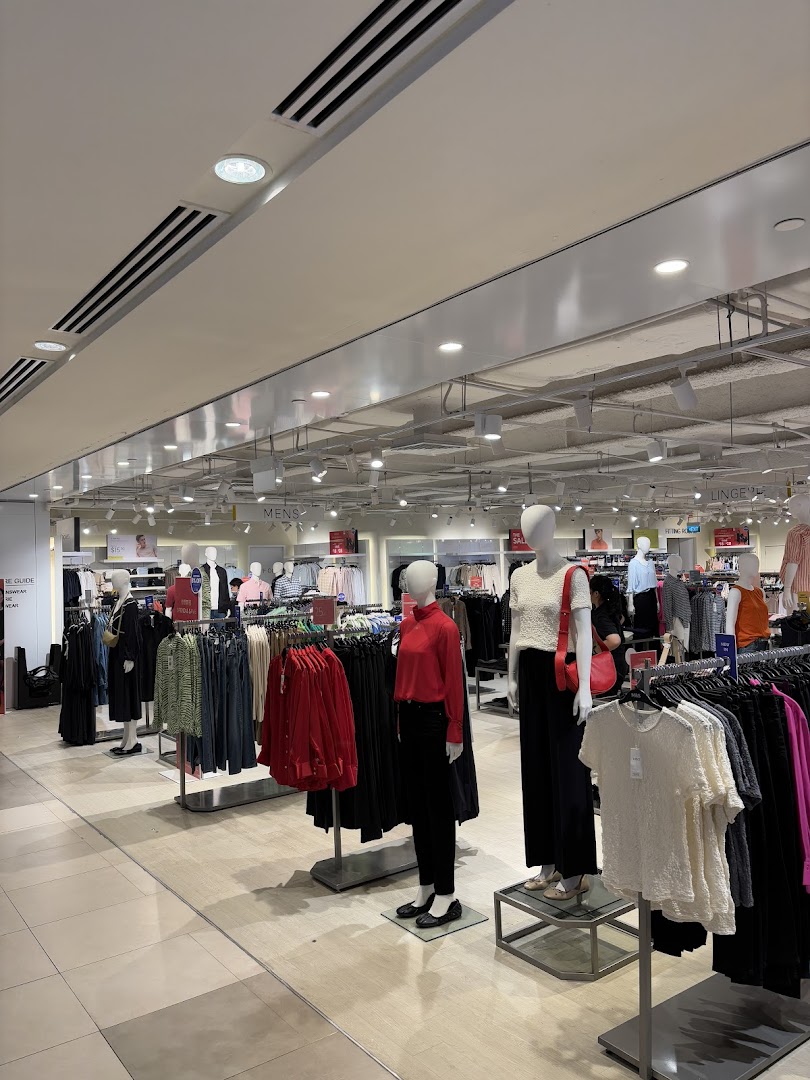 Interior view of Marks & Spencer's clothing section, featuring mannequins displaying current fashion and racks of apparel.