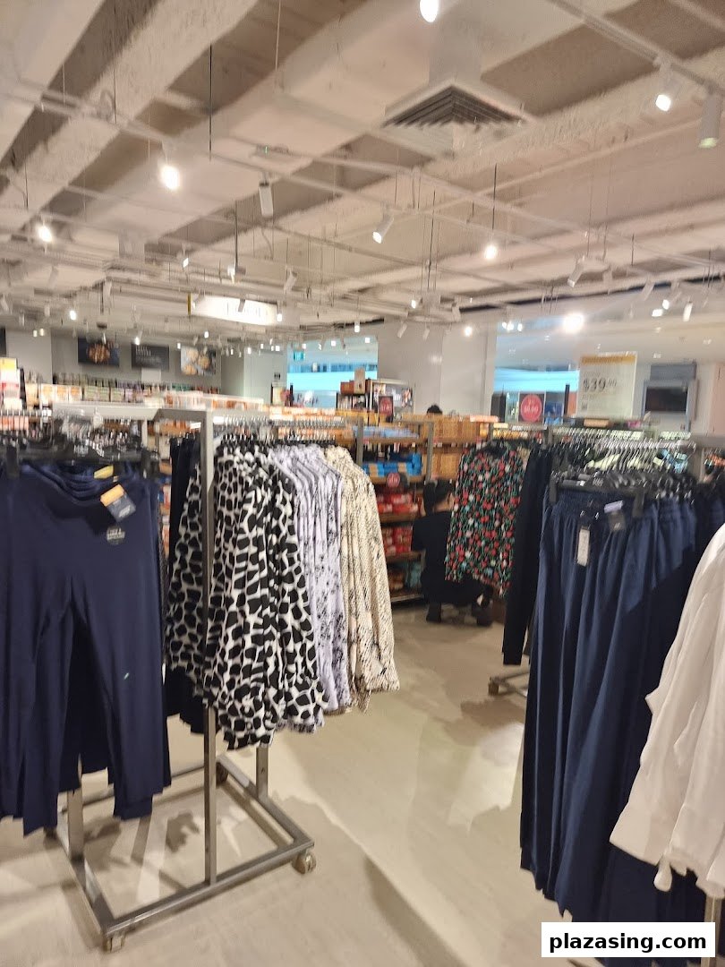 An interior view of Marks & Spencer, showcasing various clothing items on display racks.