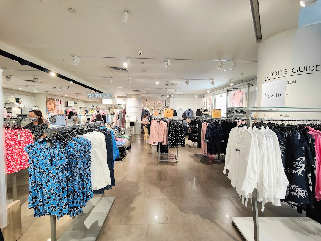 An interior view of Marks & Spencer, showcasing a wide array of women's clothing on display racks.