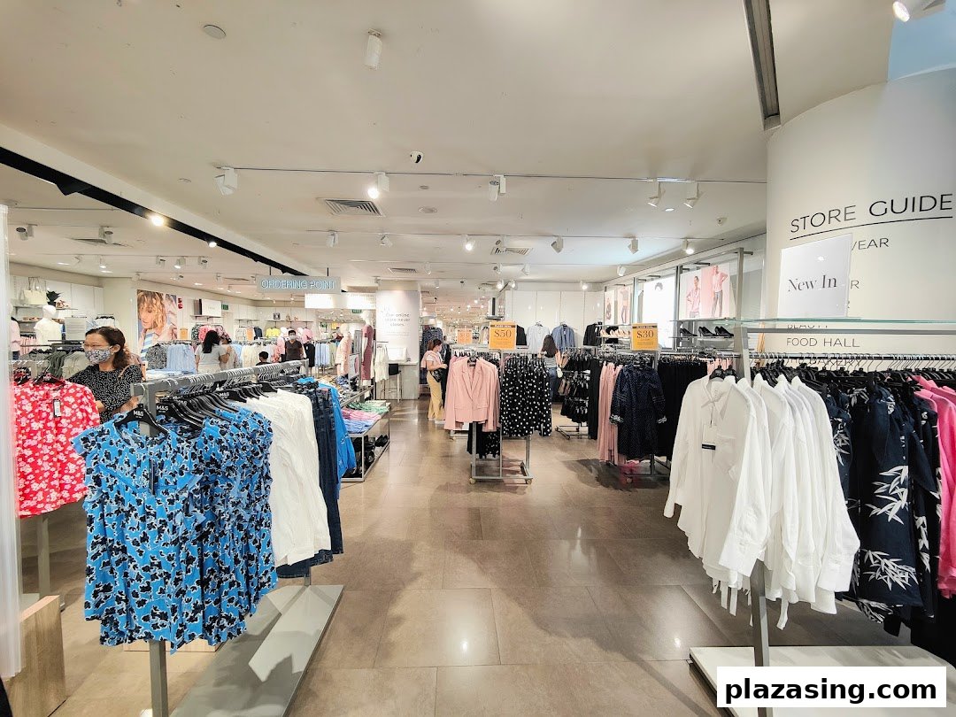 An interior view of Marks & Spencer, showcasing a wide array of women's clothing on display racks.