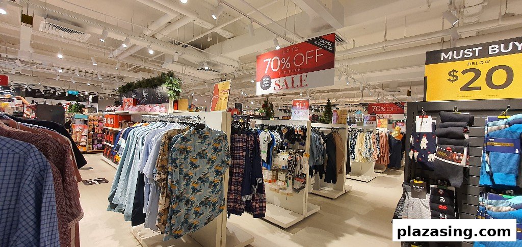 Interior view of Marks & Spencer, showcasing clothing racks and prominent sale signage.